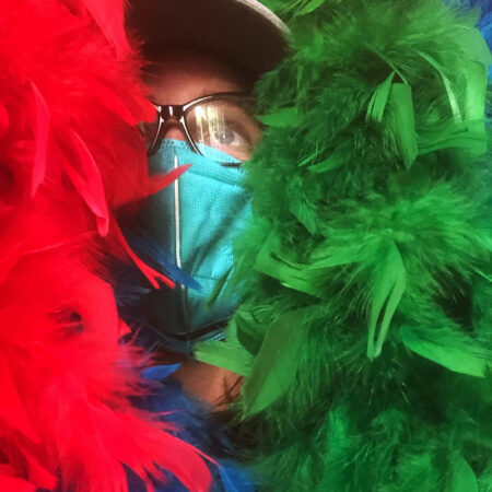 Angela Heine face between feathered boas