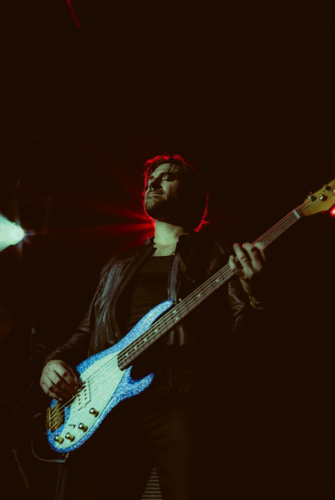 Dom Liberati performing on stage with his bass