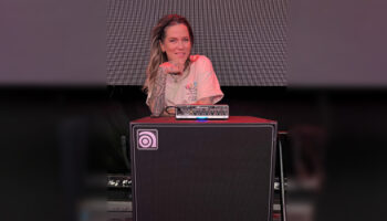 Moa Munoz standing behind and leaning on a Venture head and cab